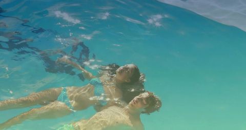 Couple Floating in Clear Turquoise Water Embracing Relaxation