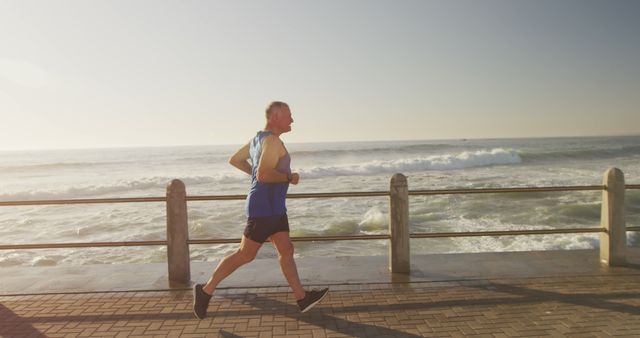 Senior Man Jogging Along Seaside Promenade at Sunrise - Download Free Stock Images Pikwizard.com