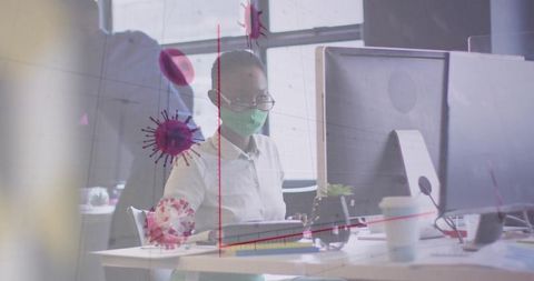 Woman working safely in office with glass partition and virus icons