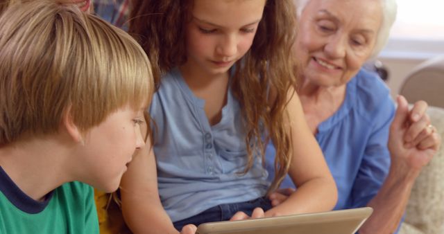 Active Grandmother Engaging with Kids Using Tablet at Home - Download Free Stock Images Pikwizard.com