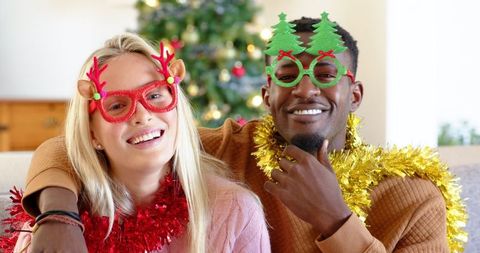Diverse couple embracing holiday spirit with festive accessories