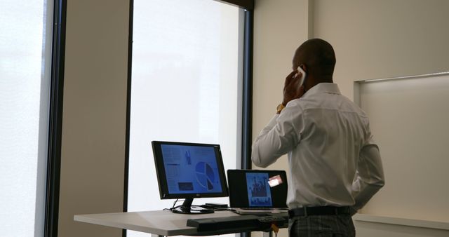 Businessman Working With Computer and Talking on Phone - Download Free Stock Images Pikwizard.com