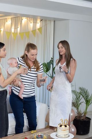 Friends Join Birthday Celebration with Cake and Laughter
