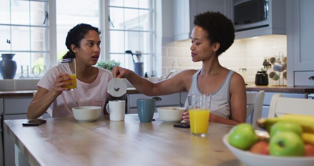 Two Women Having Breakfast in Modern Kitchen - Download Free Stock Images Pikwizard.com