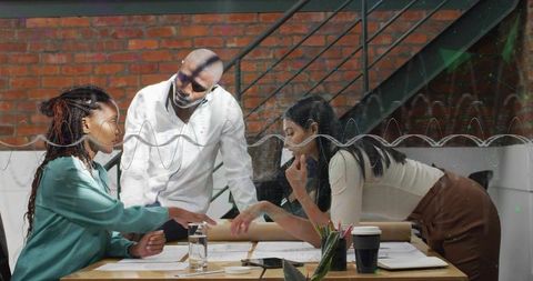 Team collaboration on construction blueprints in modern office