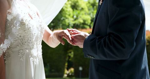 Bride and Groom Exchanging Rings in Intimate Wedding Ceremony