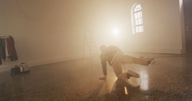 Person Crawling Under Bright Light in Minimalist Space - Download Free Stock Images Pikwizard.com