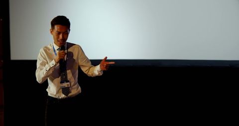 Confident Asian Businessman Delivering Presentation at Conference - Download Free Stock Images Pikwizard.com