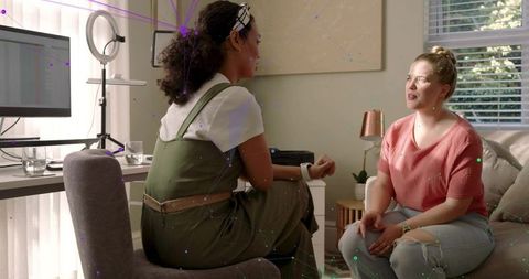 Two women collaborating in home office living room during casual consultation