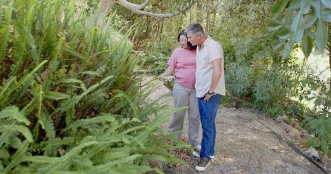 Senior Couple Gardening Together in Peaceful Garden Path
