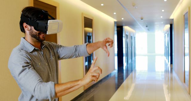Man Using Virtual Reality Headset in Modern Corridor - Download Free Stock Images Pikwizard.com