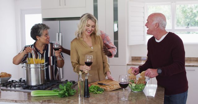 Group of Adult Friends Cooking and Enjoying Wine in Modern Kitchen - Download Free Stock Images Pikwizard.com