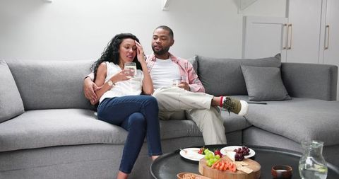 Engaged couple celebrating with relaxing home toast