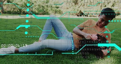 Laughing father tickling daughter on backyard lawn with futuristic digital HUD overlay