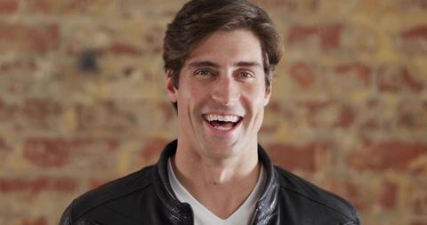 Confident Man in Leather Jacket Urban Casual Style Brick Background