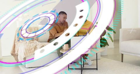 Friends collaborating over laptop with futuristic AR overlays in cozy modern living room