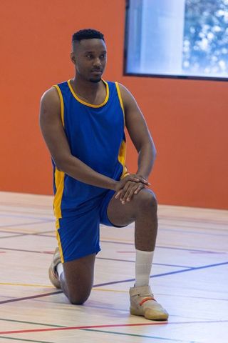 Athletic man preparing during basketball training in gymnasium