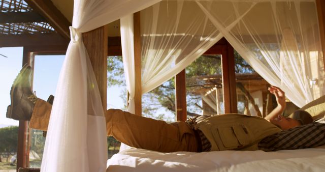 Explorer Relaxing in Sunlit Luxury Safari Cabin - Download Free Stock Images Pikwizard.com