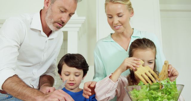 Happy Family Preparing Healthy Salad Together in Kitchen - Download Free Stock Images Pikwizard.com