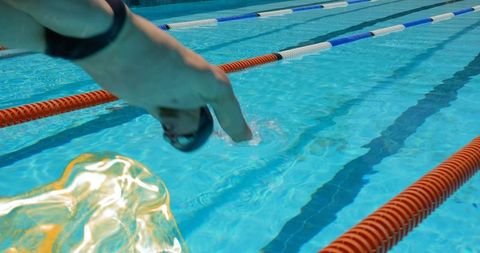 Swimmer Diving into Outdoor Competition Pool with Lane Ropes
