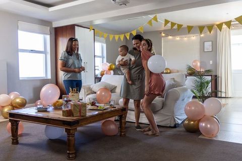 Family Embracing Child in Festively Decorated Living Room