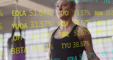 Athletic woman analyzing digital fitness metrics in studio