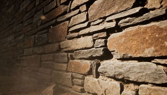 Sunlit weathered stacked stone wall showing rustic texture, dust particles, dramatic shadows