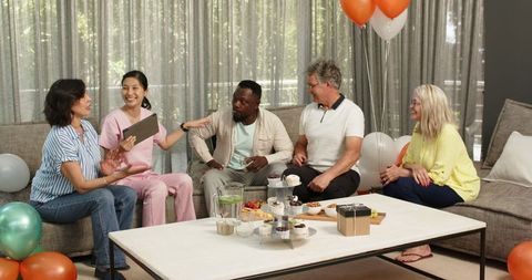 Multiracial Group Welcoming New Physiotherapy Patient in Happy Setting