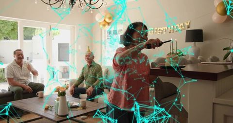 Lighting birthday candles with long lighter in open plan living room celebrating family party