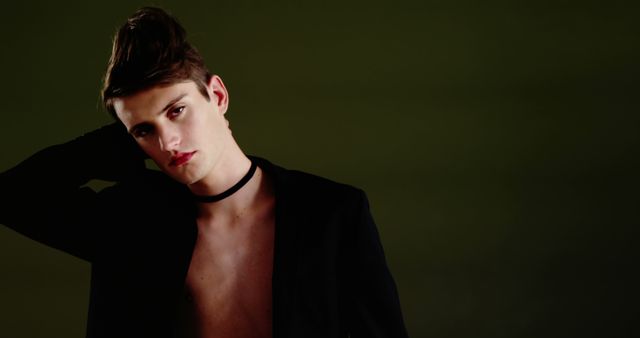 Young Man in Black Jacket Posing on Dark Background - Download Free Stock Images Pikwizard.com