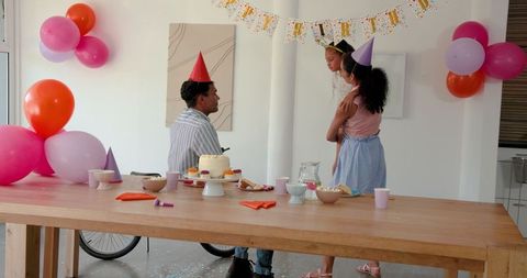 Family Celebrating Birthday Party with Cake and Decorations