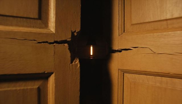 Wood doors parting revealing warm vertical tube light through cracked lock and gap