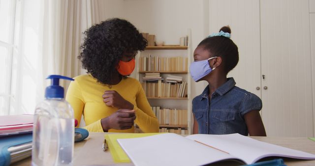 Mother and Daughter Wearing Face Masks While Studying at Home - Download Free Stock Images Pikwizard.com