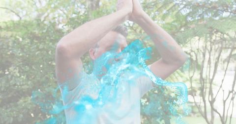 Mature man practicing yoga stretch outdoors in garden with translucent blue energy overlay