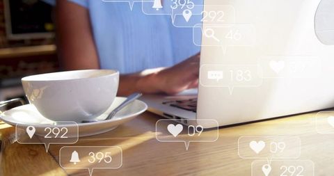 Woman typing on laptop at cafe with coffee and social media notifications overlay for remote work