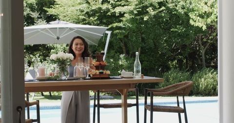 Woman Delightfully Enjoying Outdoor Brunch by Poolside