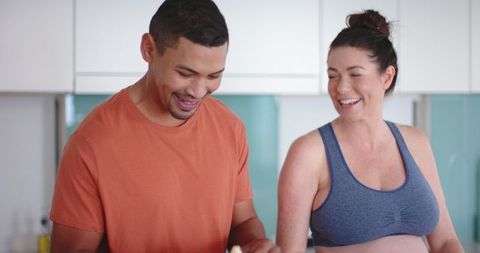 Smiling Couple Preparing Healthy Snacks in Modern Kitchen