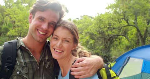 Cheerful Couple Camping in Lush Green Forest Setting