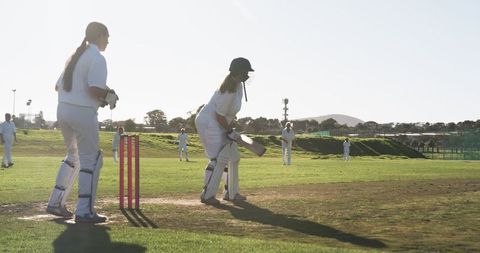 Female Cricket Players Engaged in Intense Outdoor Match