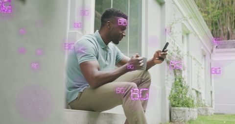Man Engaging with Smartphone Surrounded by Futuristic 6G Symbols