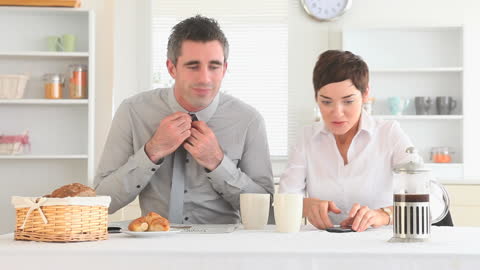 Professional Couple Preparing for Work After Breakfast