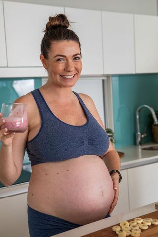 Pregnant Woman Drinking Smoothie Promoting Healthy Lifestyle