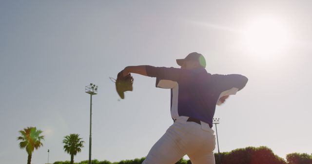 Baseball Pitcher Throwing Ball under Sunny Sky at Outdoor Ballpark - Download Free Stock Images Pikwizard.com