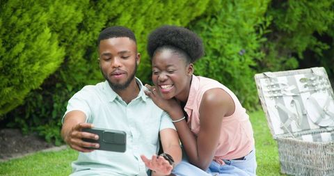 Happy Couple Taking Selfie in Lush Garden