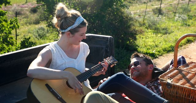 Couple Enjoying Picnic in Nature with Guitar - Download Free Stock Images Pikwizard.com