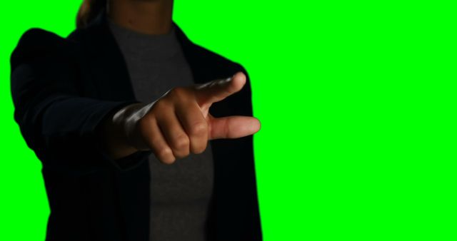 Close-up of a businessperson's hand making a touchscreen gesture against a green screen background. Useful for technology, business, and innovation themes. Ideal for demonstrating interactive interfaces, digital screens, and professional presentations.