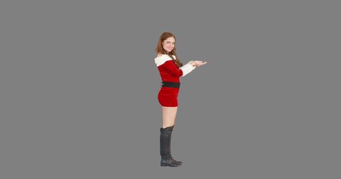 Festive woman in santa outfit presenting copy space