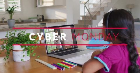 Cyber monday remote learning, girl studying at kitchen table with laptop and headphones