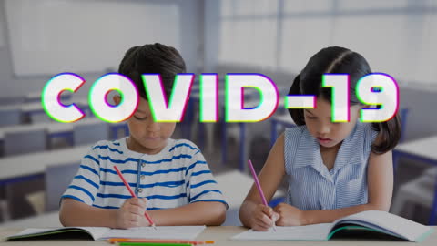 Children Studying in Classroom with COVID-19 Text Overlay