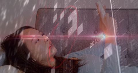 Young woman lying on sofa scrolling smartphone with futuristic hud and binary overlays